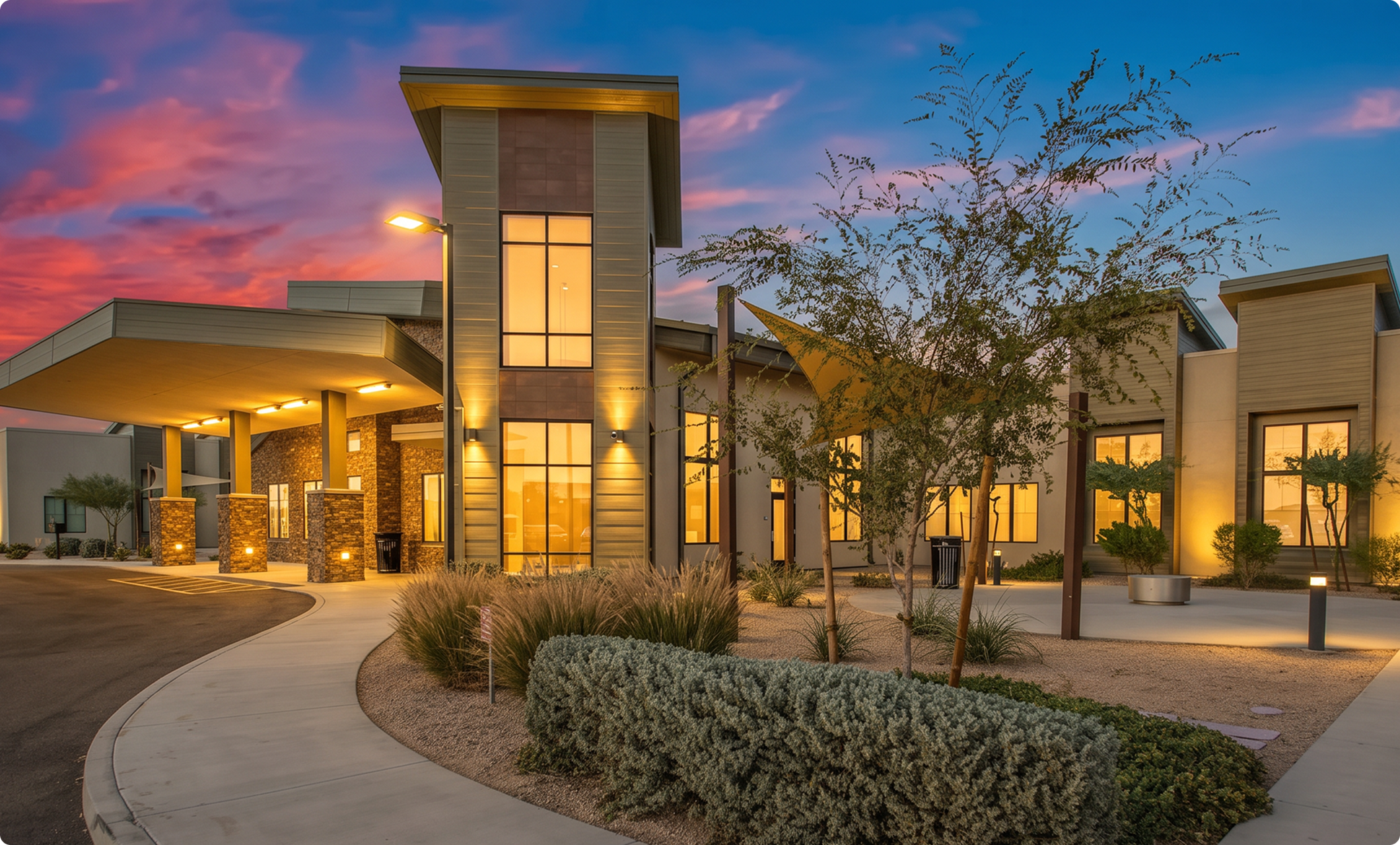 Facility exterior at evening with illuminated entrance