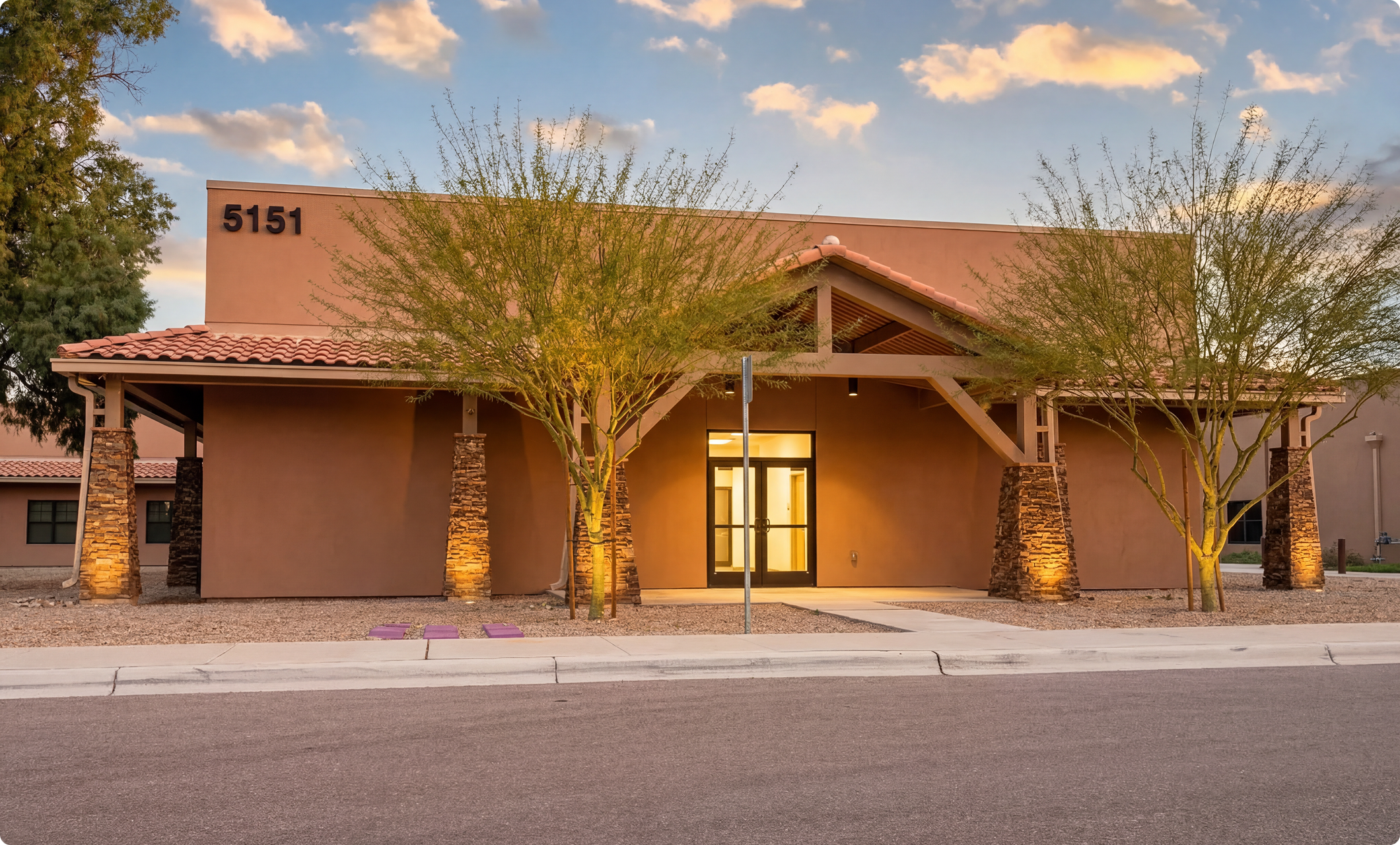Street-facing building frontage with evening lighting